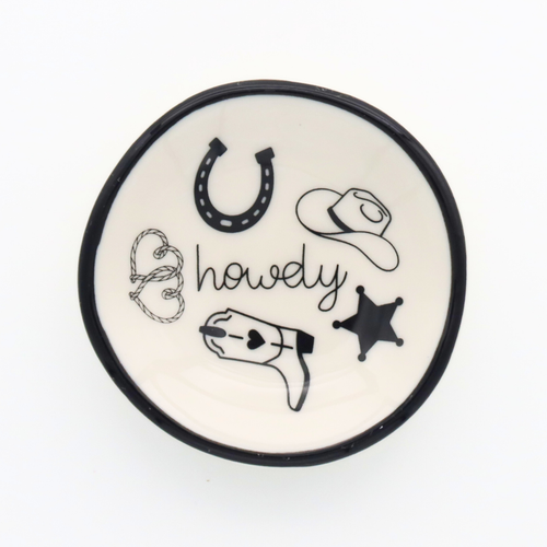 Round ceramic coaster with cowboy-themed illustrations on a white background