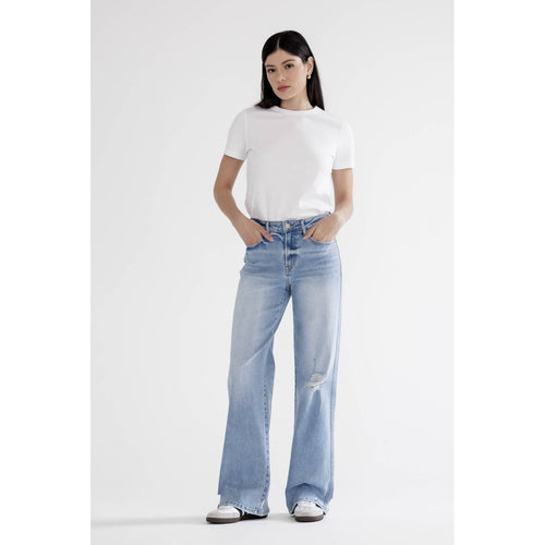 Person wearing a white t-shirt and light blue jeans on a white background