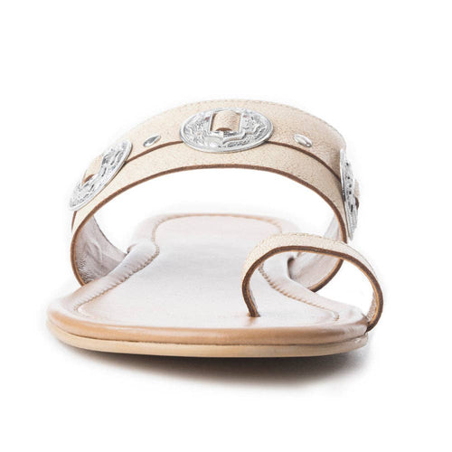 Beige sandal with decorative elements on a white background