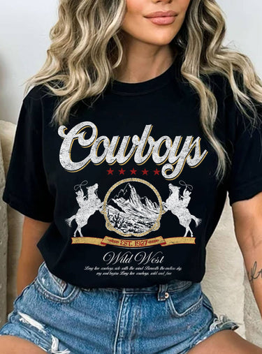 Person wearing a black t-shirt with 'Cowboys Wild West' design.