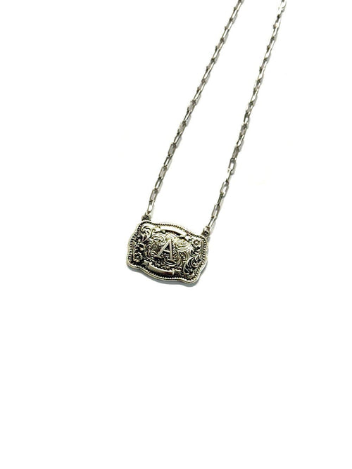Silver necklace with a decorative pendant on a white background