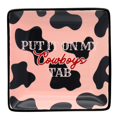 Product packaging with cow print design and text on a pink background