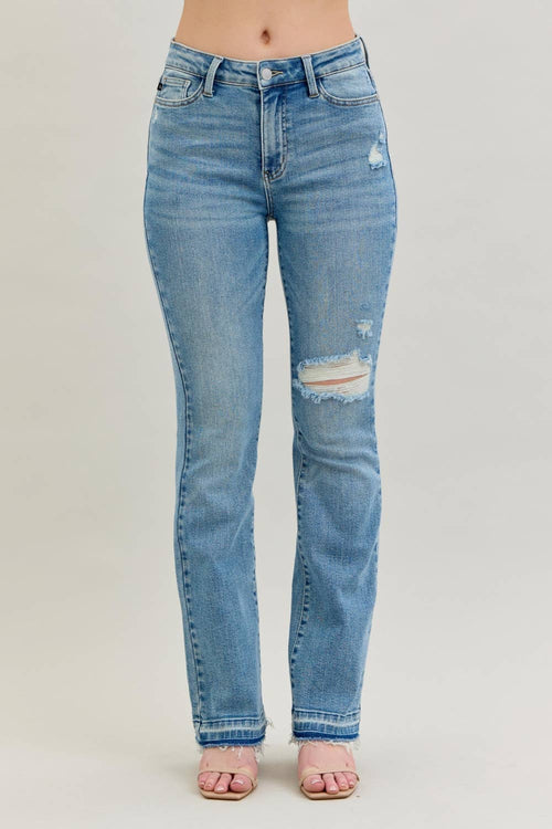 Blue jeans with slight distressing on a plain background