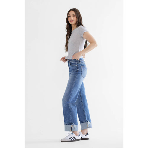 Woman wearing a gray t-shirt and blue jeans on a white background