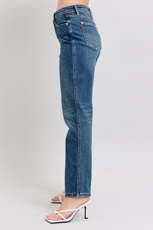 Blue jeans worn by a person on a light gray background
