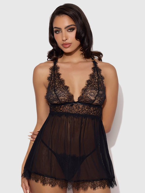 Woman wearing a black lace lingerie set on a white background