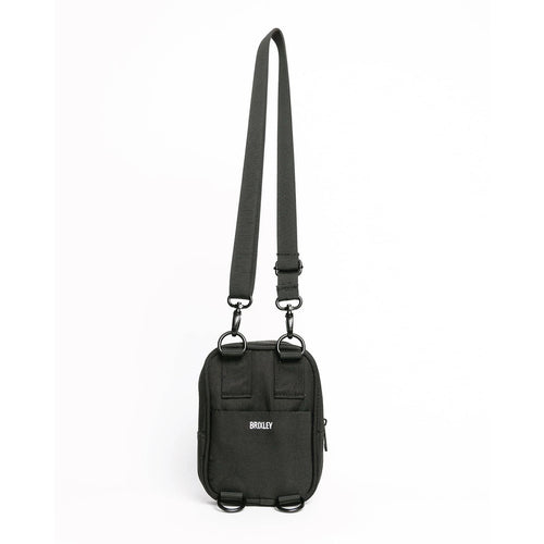 A black nylon crossbody bag with an adjustable shoulder strap, featuring a front pocket with the white 'MOULY' logo and black metal hardware, shown against a plain white background.