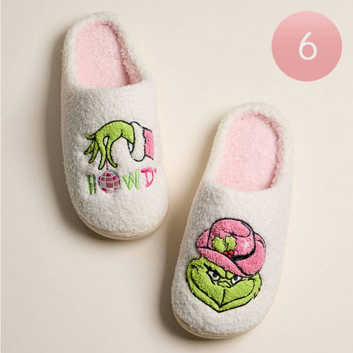 Pair of slippers with embroidered designs on a beige background