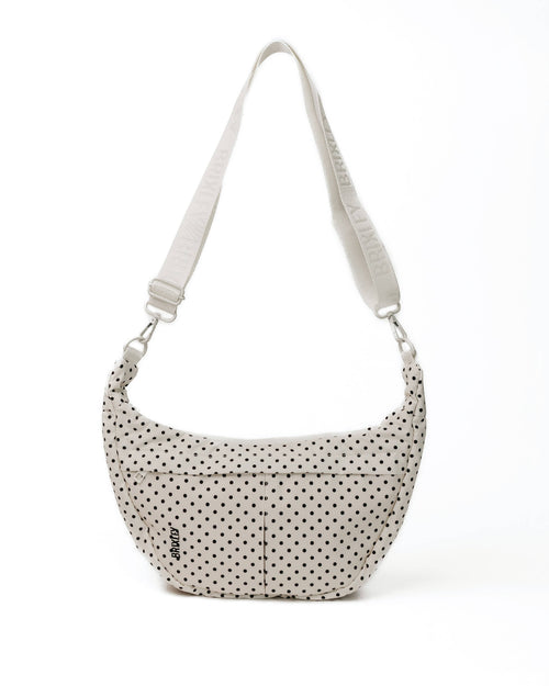 Polka dot handbag with a strap on a white background