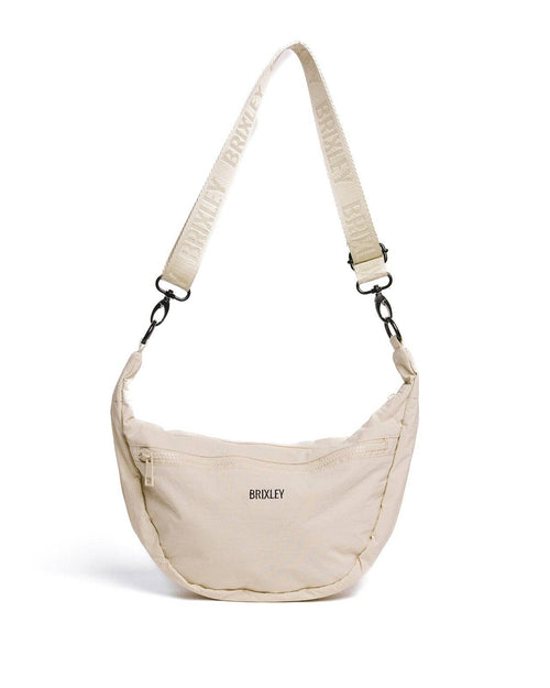 Beige shoulder bag with adjustable strap on a white background
