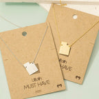 Two necklaces on brown paper with 'Utah Must Have' text on a light green background