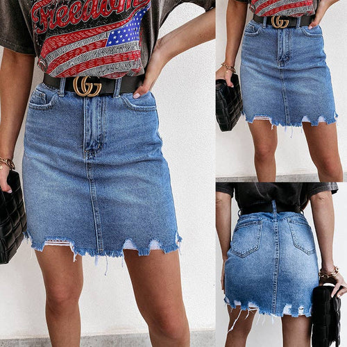 Person wearing a denim skirt with a close-up of the waistband and front view.