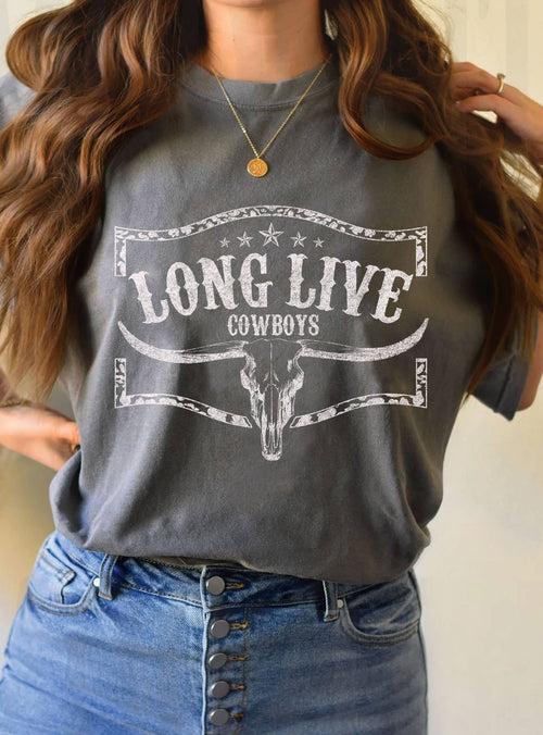Person wearing a gray t-shirt with 'Long Live Cowboys' print, standing against a neutral background.