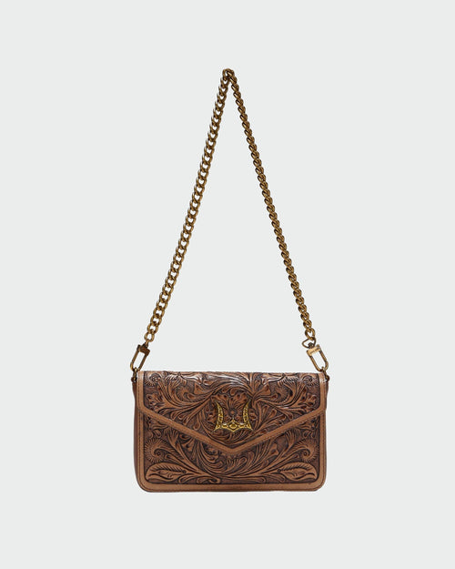 Brown leather handbag with chain strap on a light gray background