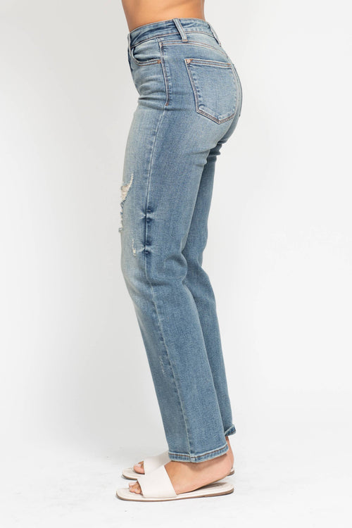 Light blue jeans worn by a person on a white background