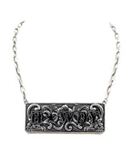 Silver necklace with 'HOWDY' pendant on a white background