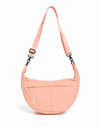 A peach-colored crescent-shaped shoulder bag with a matching adjustable shoulder strap featuring the brand name 'ALVARY' repeated, shown on a clean white background.