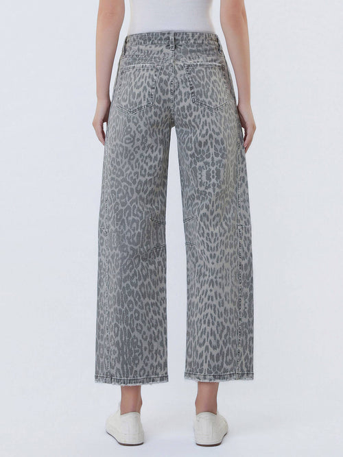 Person wearing gray leopard print wide-leg jeans on a white background