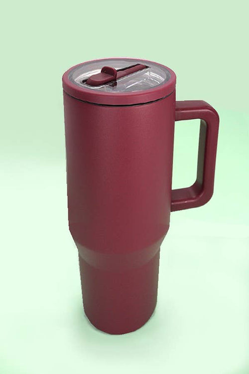 Red insulated mug with handle on a light green background