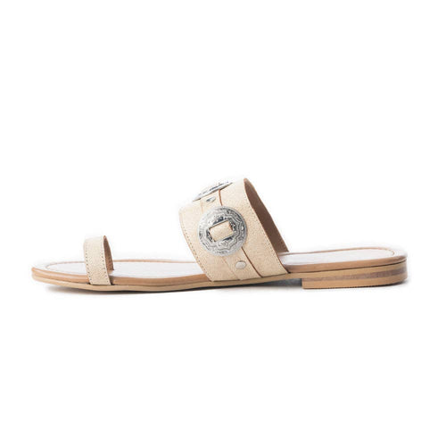 Beige sandal with a decorative buckle on a white background