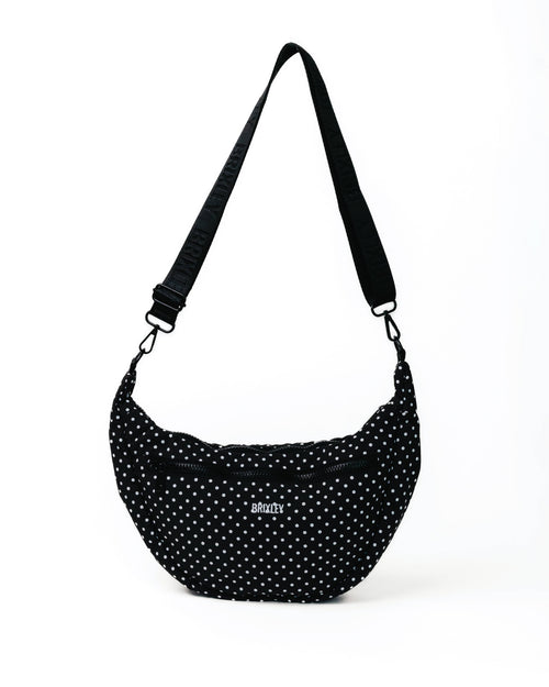Black polka dot bag with a strap on a white background