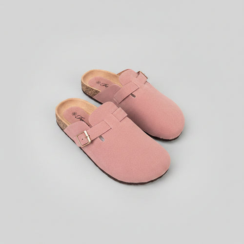 A pair of dusty pink suede clogs with cork soles, displayed on a dark gray surface. The brand name 'Freyssin' is visible on the insole.