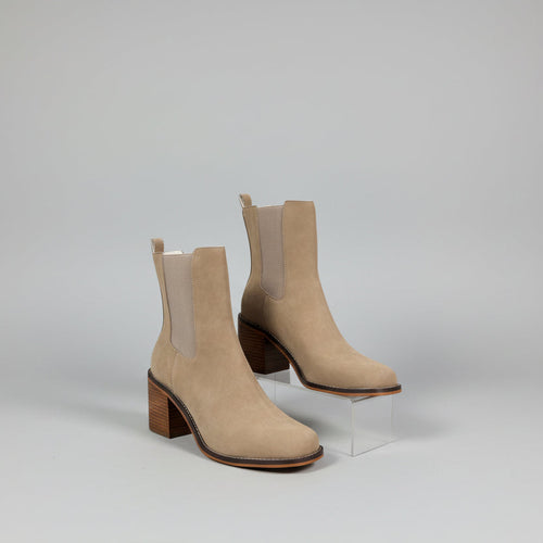Beige ankle boots with a white background