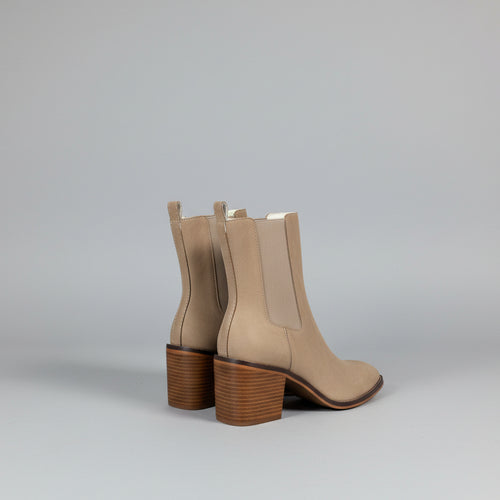 Beige ankle boots with a white background