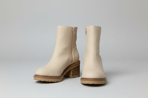 Beige Boots with a gray backdrop 