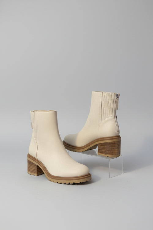 Beige Boots with a gray backdrop 