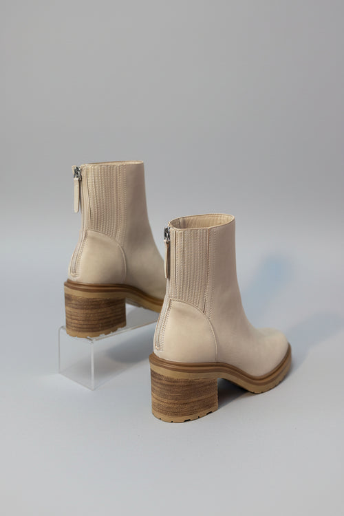 Beige Boots with a gray backdrop 