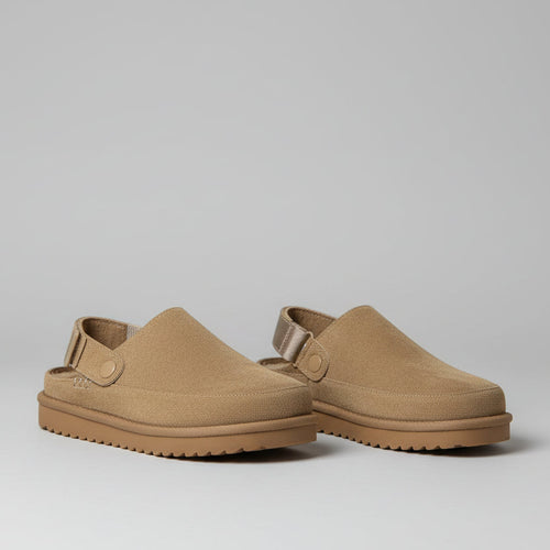 Pair of brown shoes with straps on back on a white background 