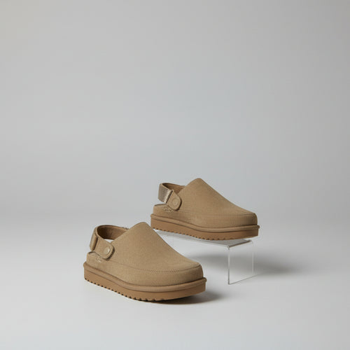 Pair of brown shoes with straps on back on a white background 