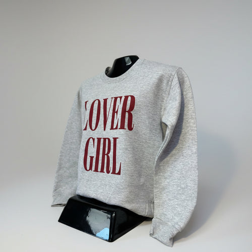 Gray sweatshirt with 'LOVER GIRL' text on a mannequin against a plain background