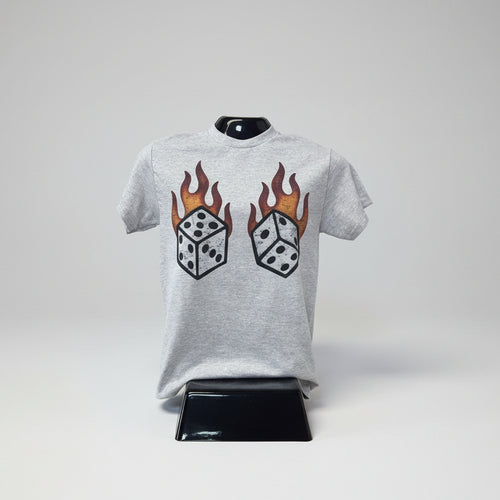 Gray sweatshirt with dice and flame design on a grey surface