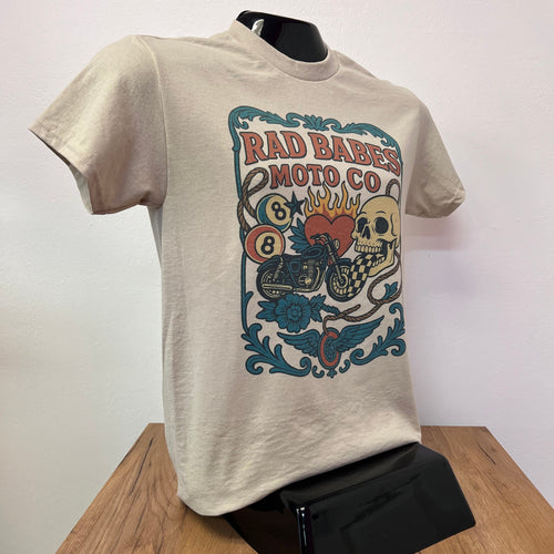 Beige sweatshirt with a colorful graphic design on a white surface with a wooden edge.