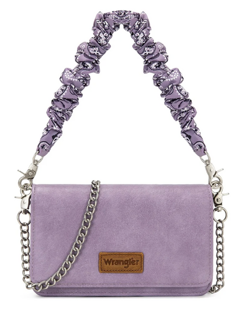 A light purple suede shoulder bag with a patterned purple and white ruffled shoulder strap, a silver chain strap, and a brown leather Wrangler logo patch on the front.