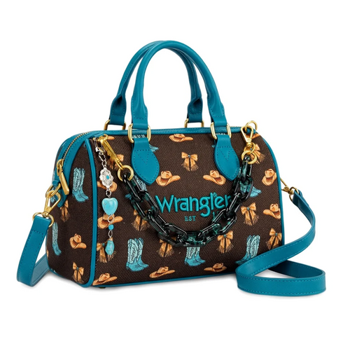 A Wrangler handbag with a brown coated canvas body featuring a western print of cowboy hats, boots, and the brand name 'Wrangler Est.' in teal and gold, with teal leather handles, a teal shoulder strap, and a chunky black chain detail.