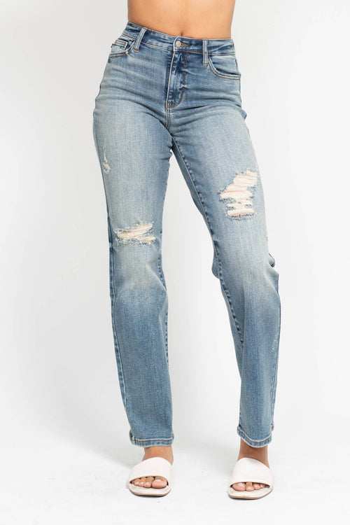 Light blue distressed jeans on a white background