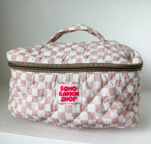 Pink and white checkered makeup bag with 'Boho Ranch Shop' label on a light background