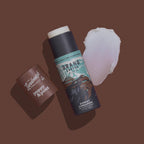 Two lip balm products on a brown background