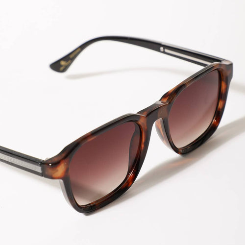 Sunglasses with tortoiseshell frame and brown lenses on a white background