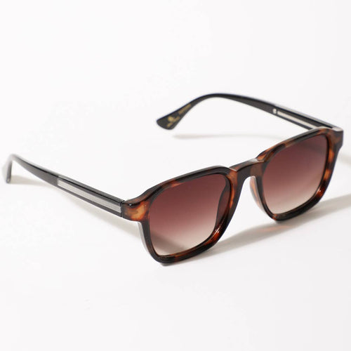 Sunglasses with tortoiseshell frame and brown gradient lenses on a white background