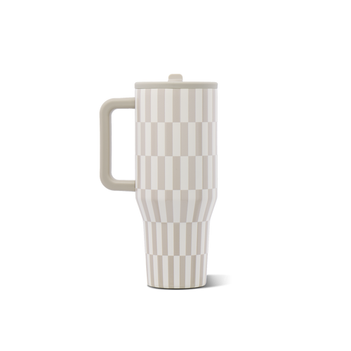 A travel tumbler with a handle and lid, featuring a beige and off-white geometric checkerboard pattern, shown on a solid white background.