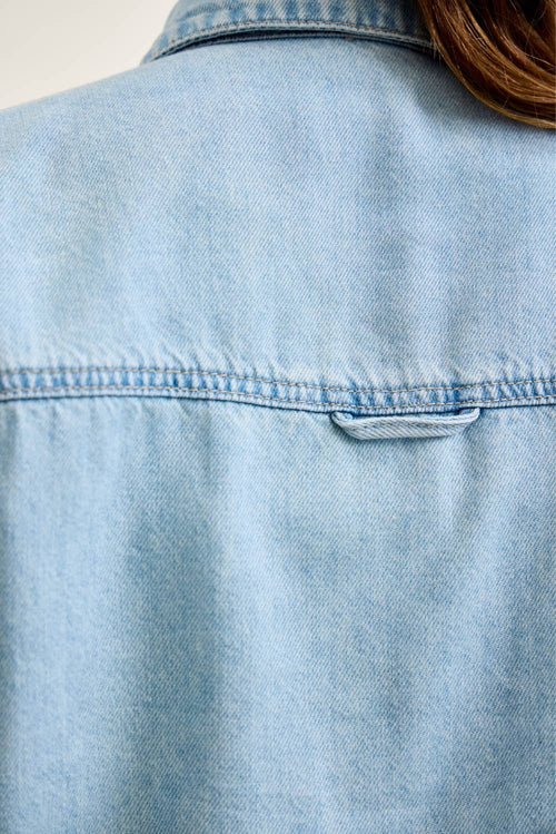 Light blue denim jacket with a blurred background