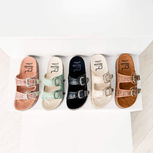 Five pairs of VR sandals in various colors on a white surface.