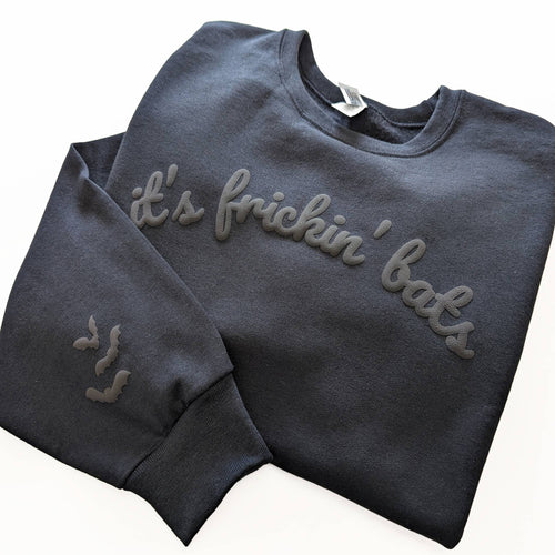black sweatshirt with its frickin bats wrote on it on white background 