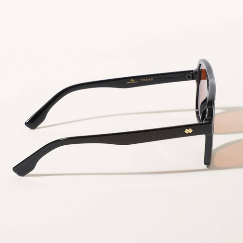 Black sunglasses with gold accents on a white background