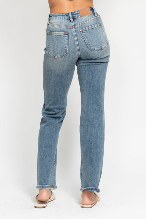 Light blue jeans worn by a person on a white background