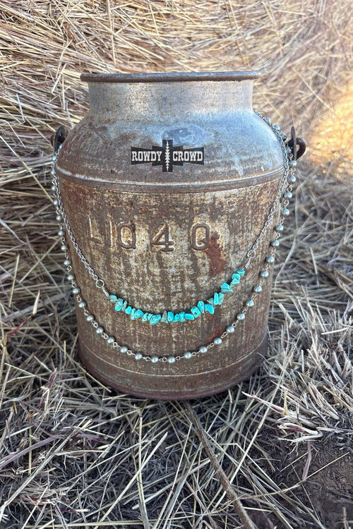 Rustic metal container with decorative elements on a grassy background